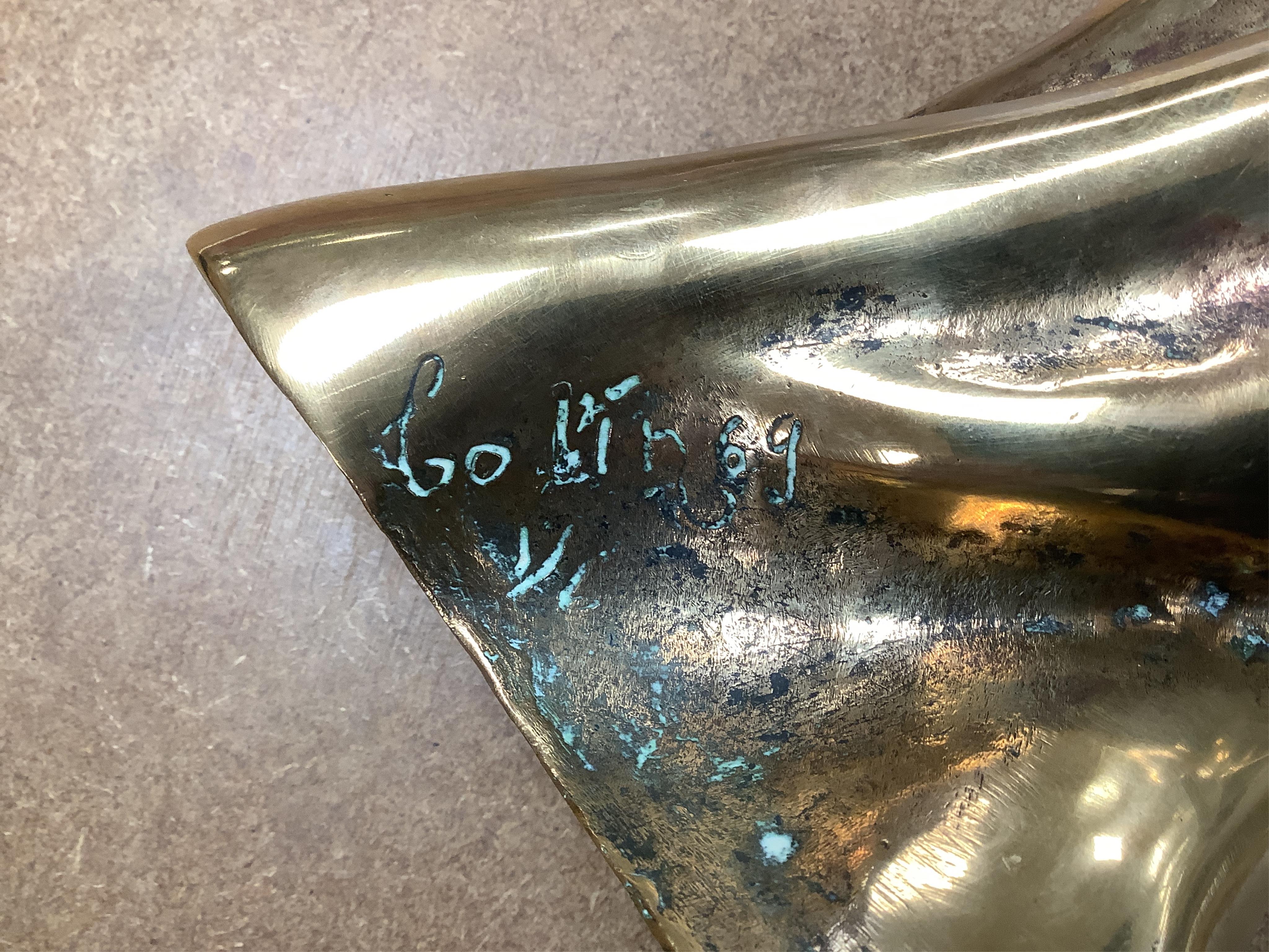 A modernist polished bronze sculpture, two entwined figures, indistinctly signed, 23cm high